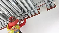 A worker applying a fire prevention measure