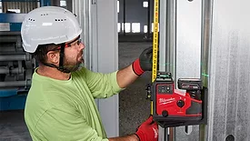 A man using lasers to take measurements