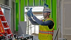 A man using technology to take measurements