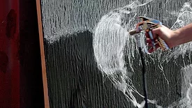 Quick-Grip-Adhesive-being-sprayed-onto-LM60-Waterproofing-membrane
