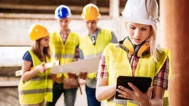 YOung construction workers using technology